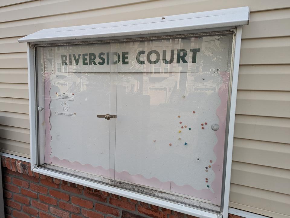 Riverside Court notice board, affixed to the pool building