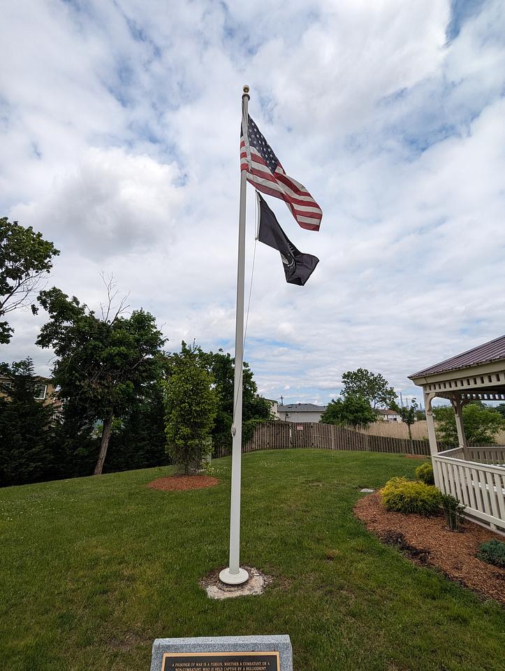 Flagpole flying an American flag and a POW/MIA flag.