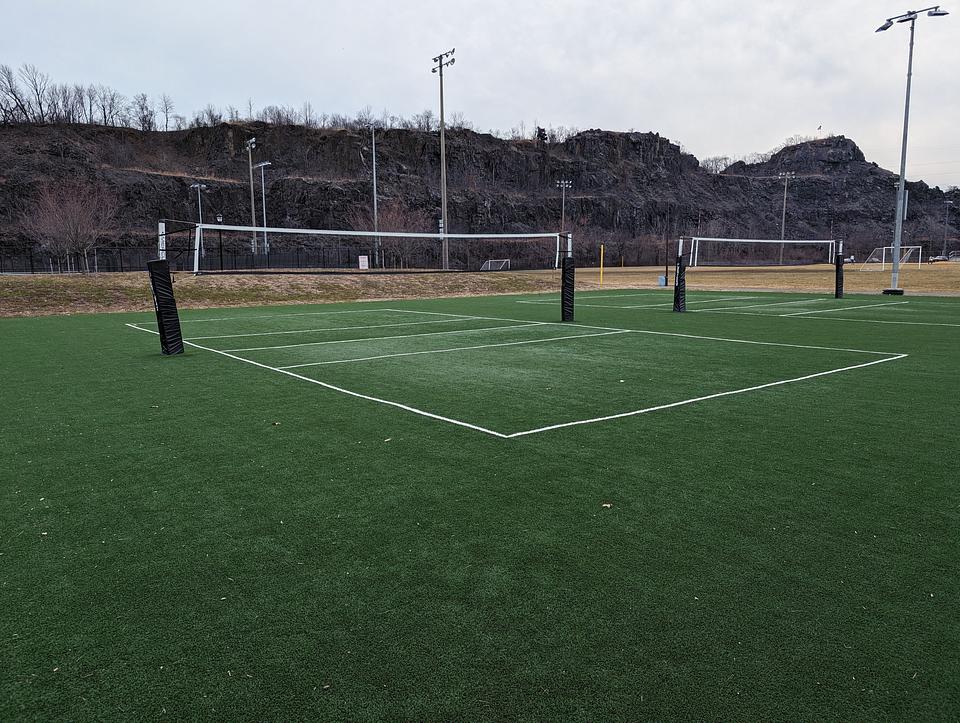 Two badminton courts made of artificial turf at Laurel Hill Park. Snake Hill is visible in the background.